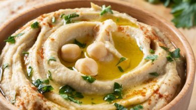 Smooth and creamy classic hummus in a bowl with pita